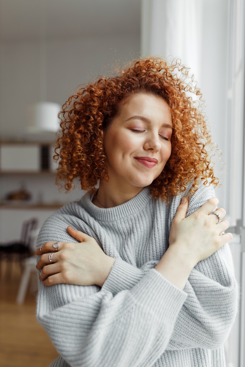 Women hugging herself (self-love)